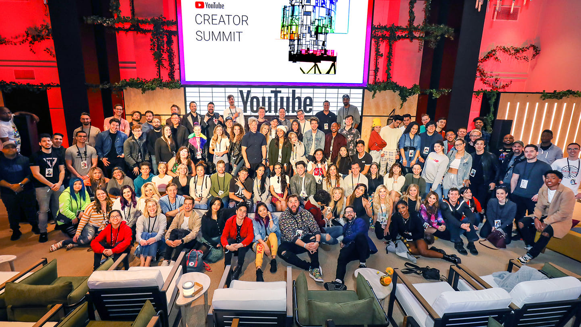 People taking a picture in front of the stage at the YouTube creator summit.